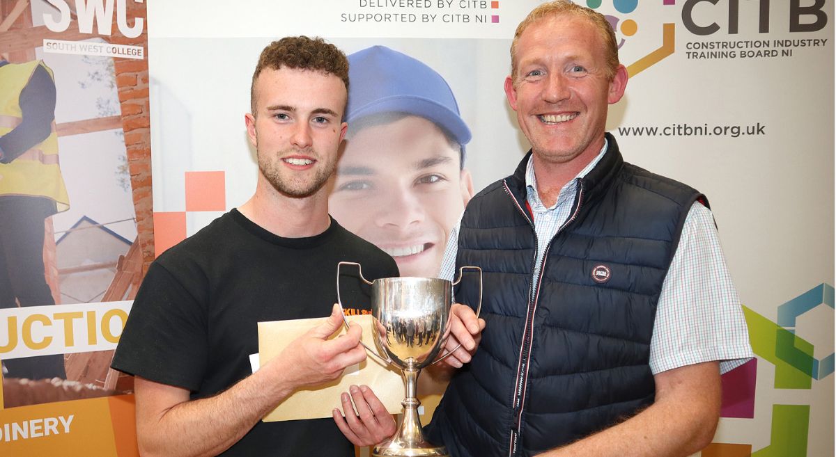 Luke McIlwraith (on the left) and tutor Francis Rice with the cup awarded to Luke as Apprentice of the Year at the NI SkillBuild Regional Competition